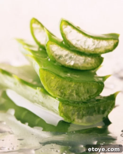 A bottle of aloe vera gel next to a bowl of ice, symbolizing the cooling relief of chilled skincare products.