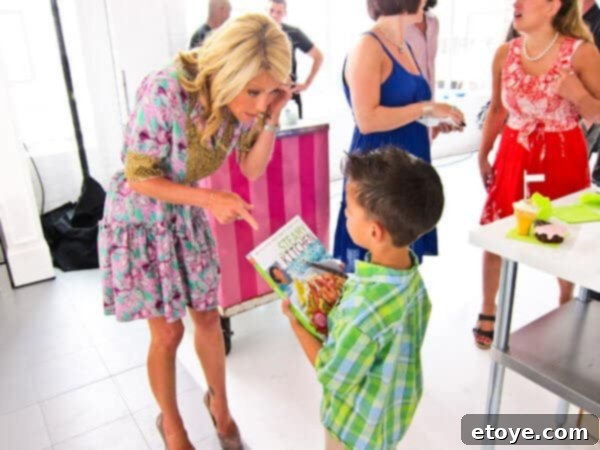 Nathan autographing a cookbook for Kelly Ripa