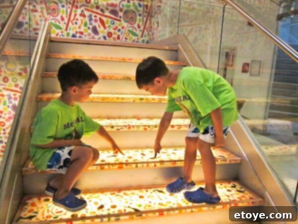 Kids trying to pick candy from the stairs in a candy store