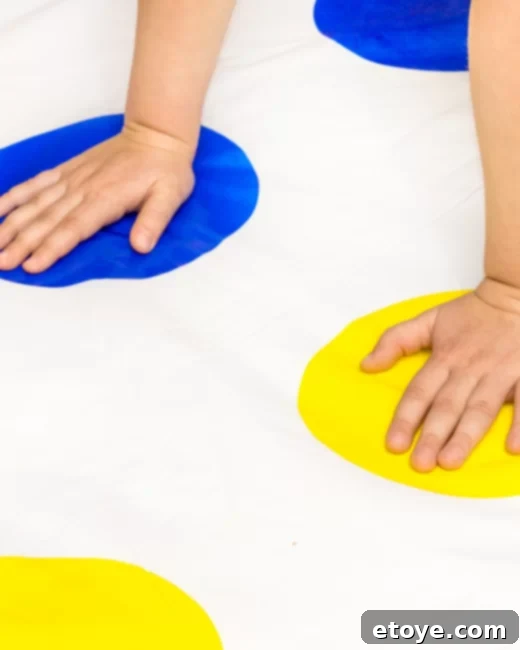 Epic Paddle Board Sweepstakes 5 People playing a wet game of Twister on a green lawn with water