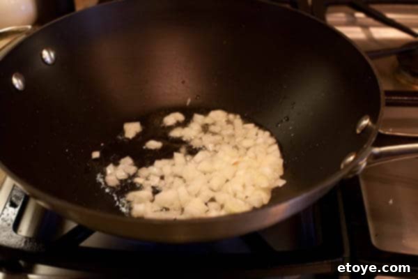 Bulgogi Rice Bowl 8 Onions being sautéed in a wok