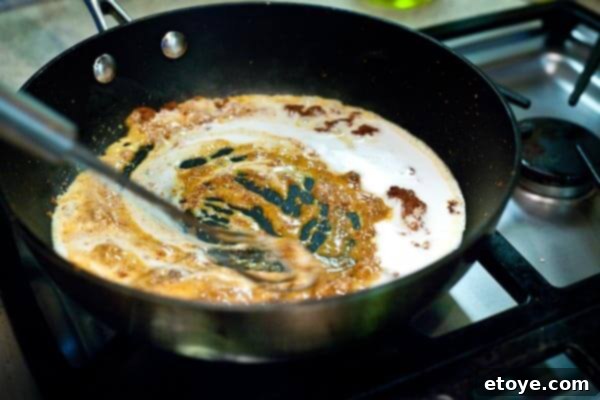 10-Minute Shrimp & Mushroom Thai Curry 6 Pouring coconut milk into the skillet with curry paste