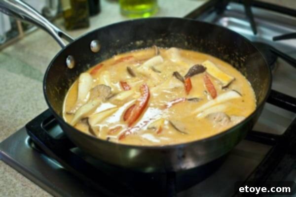 10-Minute Shrimp & Mushroom Thai Curry 9 Mushrooms and bell peppers cooking in Thai curry sauce