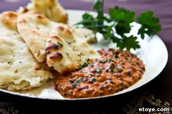 Indian Dal: Culinary Enlightenment 5 A beautifully presented bowl of freshly prepared Dal Nirvana, generously garnished with bright green, minced cilantro leaves, signifying its readiness to be enjoyed.