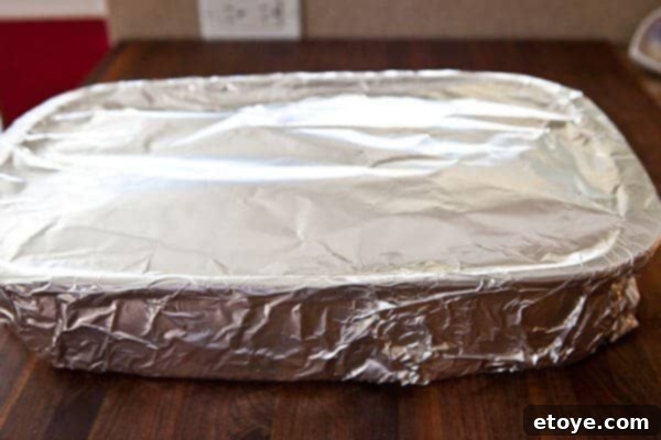 Fall-Off-The-Bone Sweet Chili Ribs 12 Roasting pan covered tightly with a double layer of aluminum foil, ready for 4 hours of baking at 275F to ensure the most tender baby back ribs.