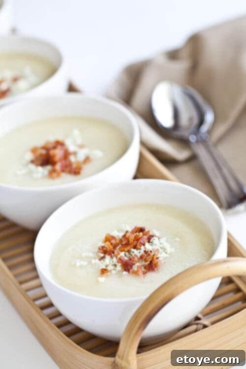 Close-up of creamy cauliflower soup garnished with crispy bacon