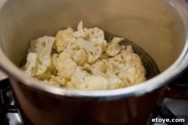 Steaming cauliflower florets in a pot