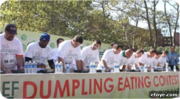 A determined female contestant intently focused on devouring dumplings during the intense, timed competition