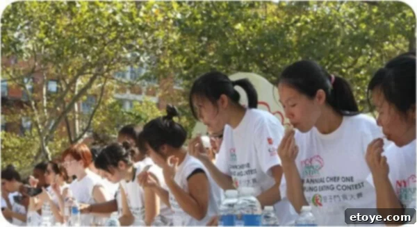Two poised female contestants demonstrating their swift and clean eating techniques during the competitive event