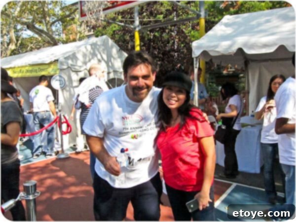 Joe Manchetti, a renowned competitive eater, striking a confident pose with a broad smile and an enthusiastic thumbs-up