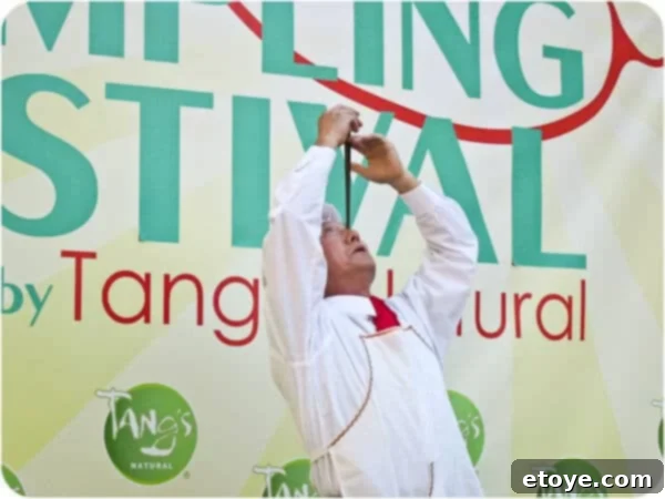 Mr. Yan Xiao Di demonstrating extraordinary skill by perfectly balancing a chopstick on his nose