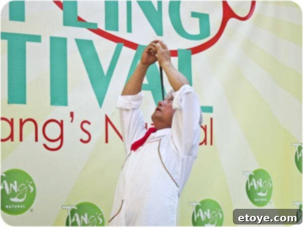 Mr. Yan Xiao Di holding the intricate chopstick and egg balance with profound concentration and stillness