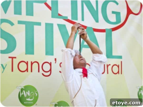 Mr. Yan Xiao Di maintaining his remarkable balance with the chopstick and egg, a moment of profound artistry and suspense