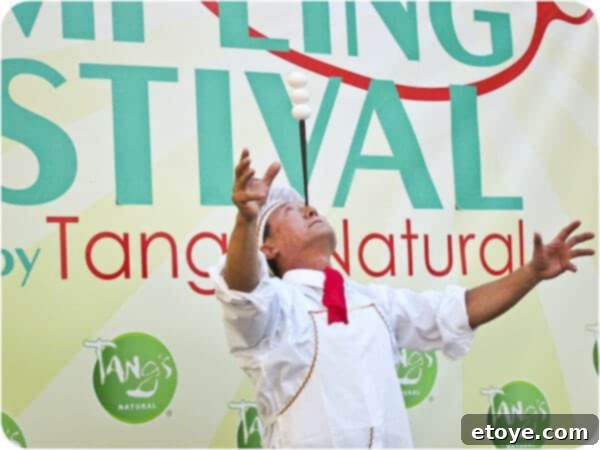 Mr. Yan Xiao Di expertly concluding his challenging chopstick and egg balancing act, a moment of triumph and relief