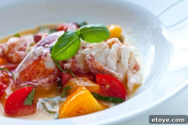 butter poached lobster in serving dish with herbs