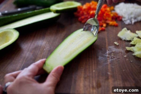 Scooping out zucchini flesh