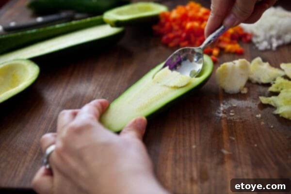 Continuing to scoop zucchini