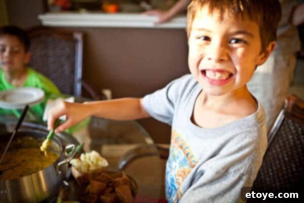 Hearty Spinach Mushroom Bacon Fondue 6 Child dipping asparagus in fondue