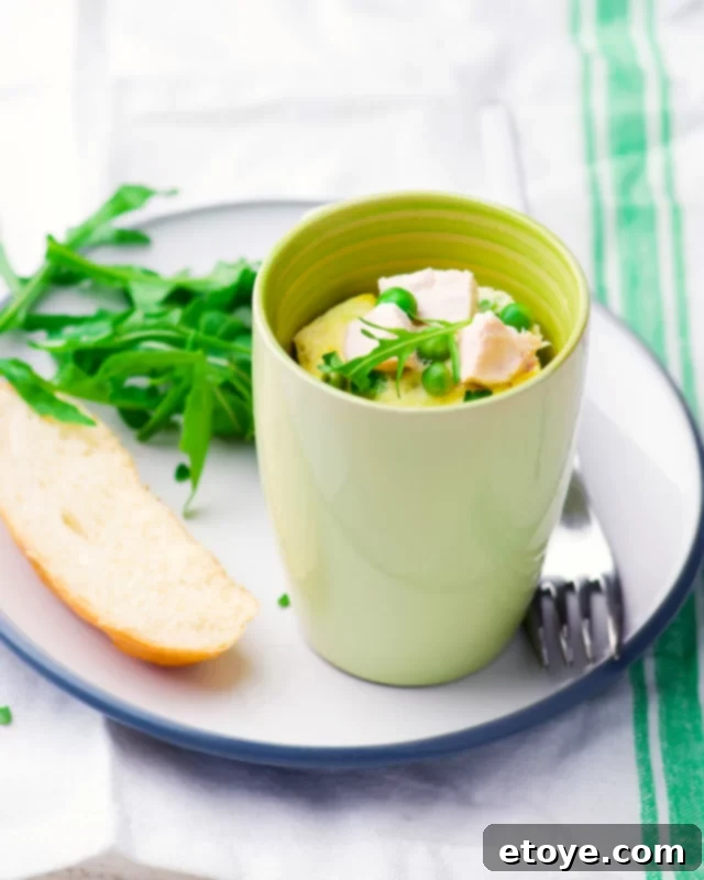 Quick-Fix Quiche Cup 2 protein-packed microwave quiche with chicken and peas in a green mug, garnished with fresh herbs, ready for a quick and healthy breakfast.