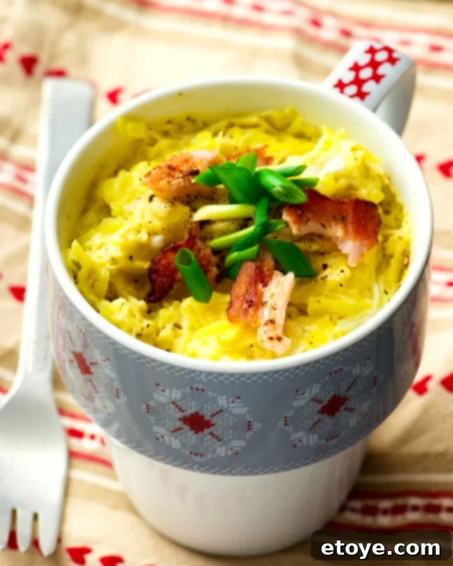 Quick-Fix Quiche Cup 5 Close-up of a flavorful bacon and egg quiche in a blue and white mug, topped with fresh scallions, ready for a delicious breakfast.