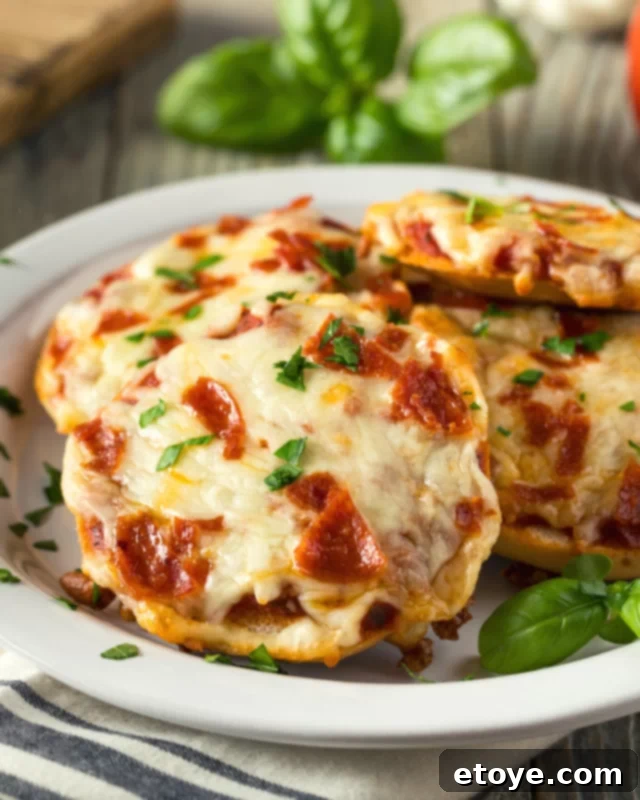Pizza bagel bites with pepperoni and fresh parsley garnish.