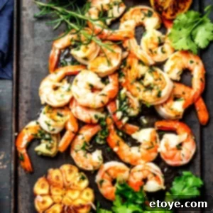 Garlic Shrimp in Minutes 7 Cooked garlic shrimp on a sheet pan with fresh parsley.