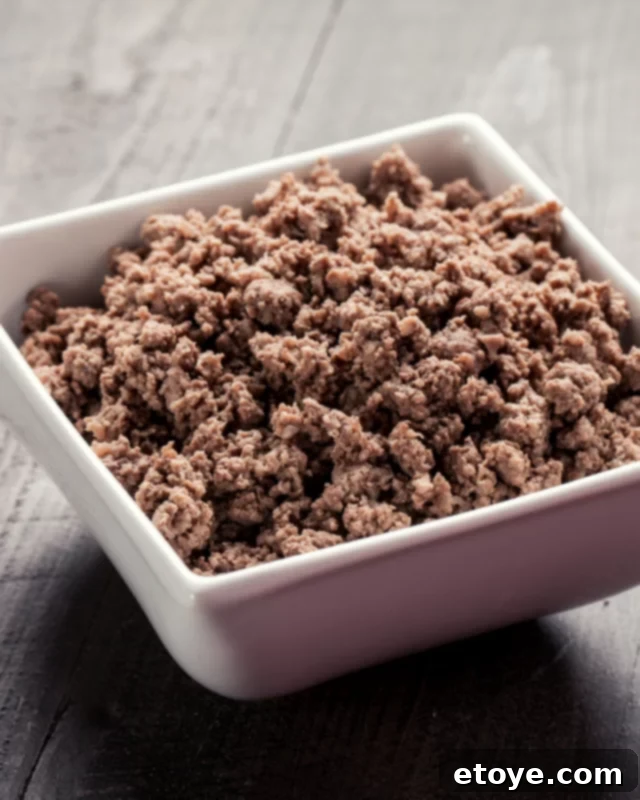 Microwave Magic: Quick Ground Beef Dishes 2 cooked ground beef in a white bowl.