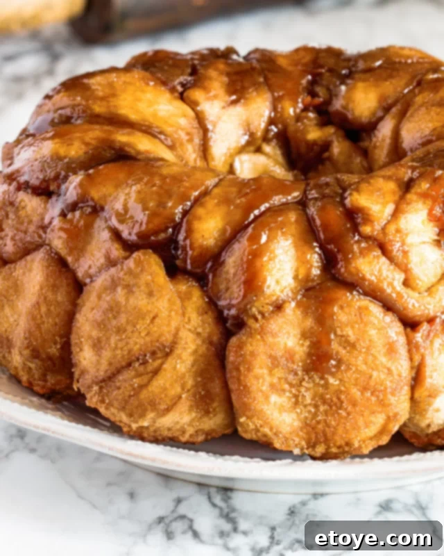 Biscuit dough covered in cinnamon sugar on a white plate. 
