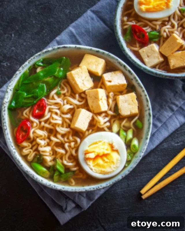 Elevate Your Microwave Ramen 5 Two steaming bowls of homemade ramen noodle soup, expertly prepared and garnished, showcasing the vibrant colors and appealing textures of a delicious, quick meal.
