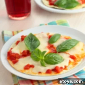 Freshly made tortilla pizza with mozzarella and basil on a white plate, ready to be eaten.