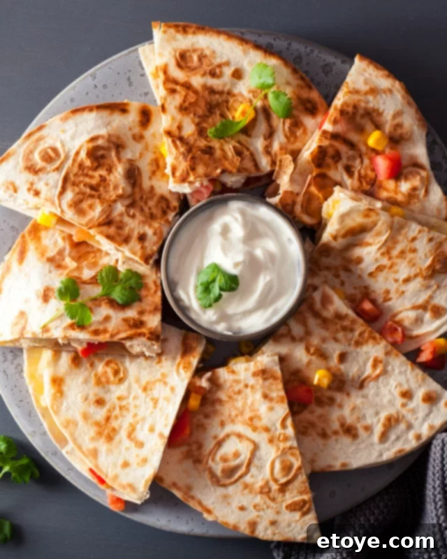 Instant Microwave Quesadillas 4 Plate of quesadillas next to a bowl of sour cream.
