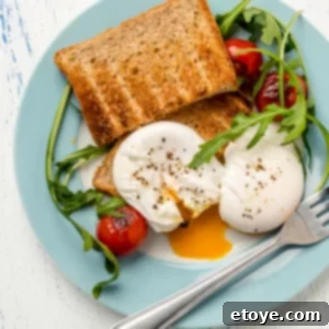 Easy Microwave Poached Eggs 6 Two perfectly poached eggs with a fresh salad on a blue plate, ready to be enjoyed as a gourmet breakfast.