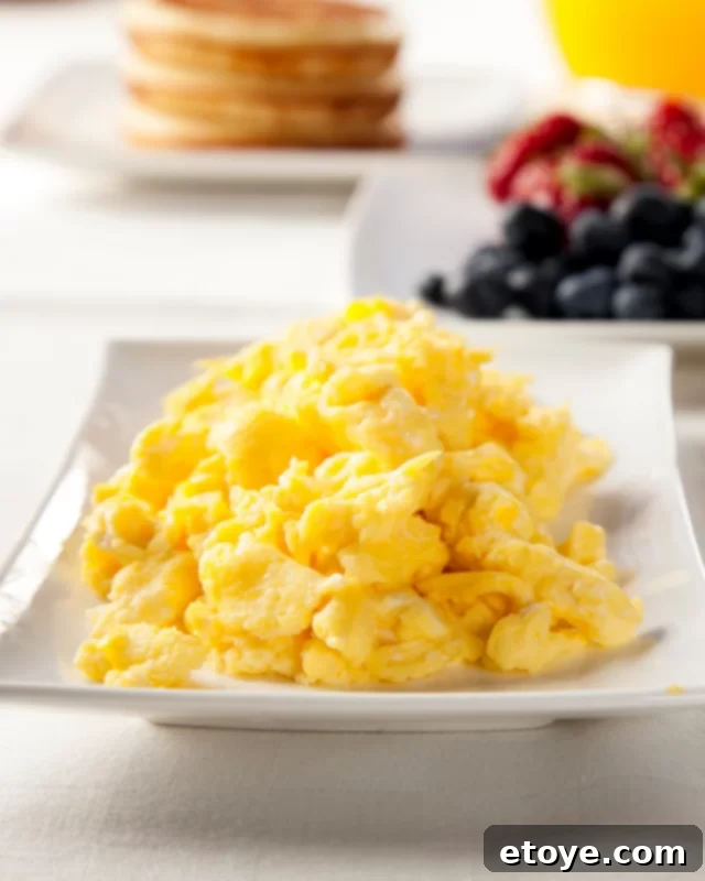 Speedy Microwave Scramble 4 scrambled eggs on a white plate with berries.