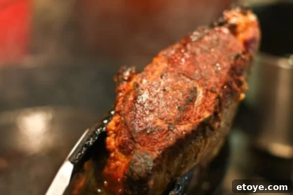 Another close-up showing the golden-brown crust on the seared prime rib.
