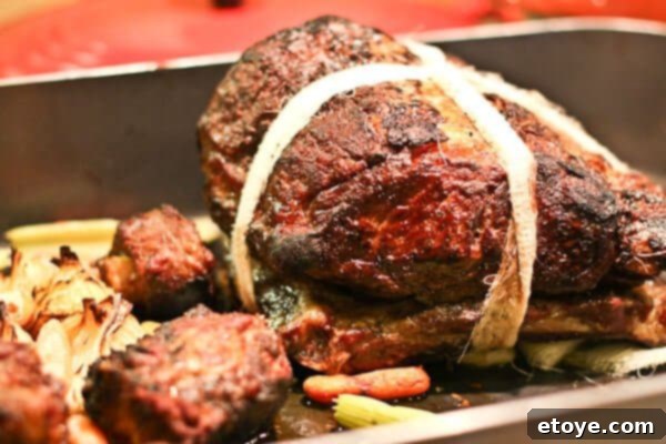 Prime rib roast cooking slowly in the oven, achieving perfect doneness.