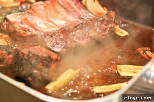 Red wine jus simmering to perfection in the pan, extracting maximum flavor.