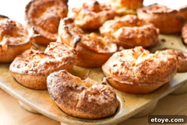 Best Yorkshire Puddings baked in a muffin pan, golden brown and perfectly risen, ready to serve.