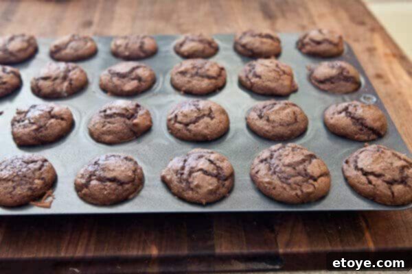 Using a tart shaper to create indentations in warm cupcakes