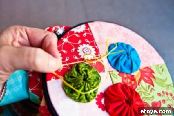 Whip Up Your Own Kitchen Hand Towels 29 Pulling Needle Through to Form French Knot