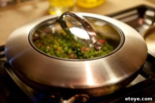 Crispy Bacon and Sweet Peas 11 A close-up of the finished peas and bacon dish in a pan, ready to serve.