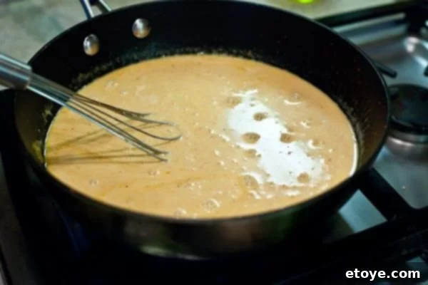 Lightning-Fast Thai Shrimp Curry 6 Close-up of the simmering coconut milk and curry paste mixture