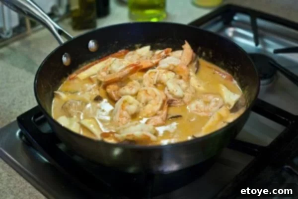 Lightning-Fast Thai Shrimp Curry 8 Shrimp cooking in the vibrant Thai curry sauce