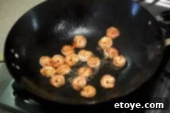 Stir frying shrimp for Shrimp and Zucchini Stir Fry and Crispy Basil