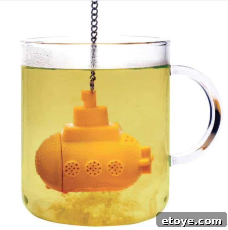 submarine-tea-infuser A charming submarine-shaped tea infuser steeping in a mug of tea, creating a delightful and whimsical tea-drinking experience.