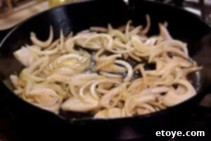 Onions sauteing in butter in the skillet