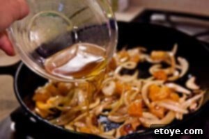 Adding brandy to the simmering apricot and onion mixture