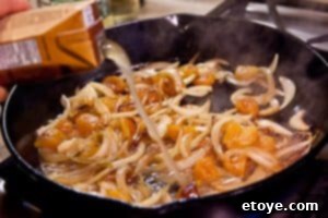 Pork chops simmering in apricot brandy sauce