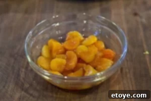 Dried apricots soaking in brandy for flavor infusion