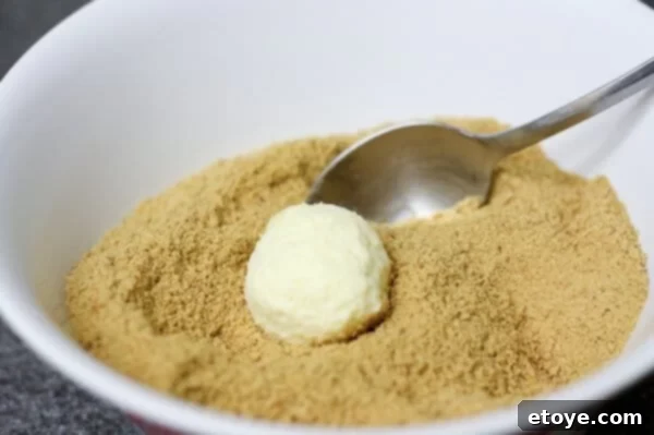 Rolling cheesecake balls in graham cracker crumbs