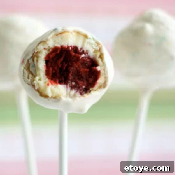 Homemade Red Velvet Cheesecake Pops on a cooling rack